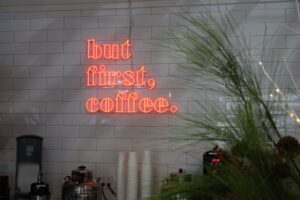 The 'but first, coffee.' neon sign at The Filling Station. 