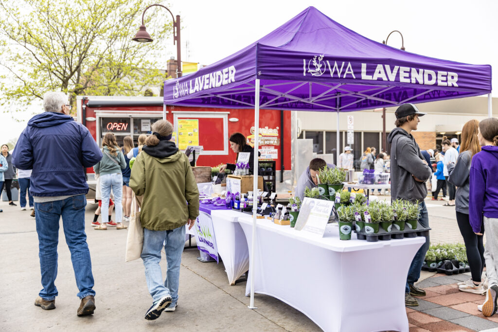Iowa Lavender Farmers Market tent with people walking by and shopping