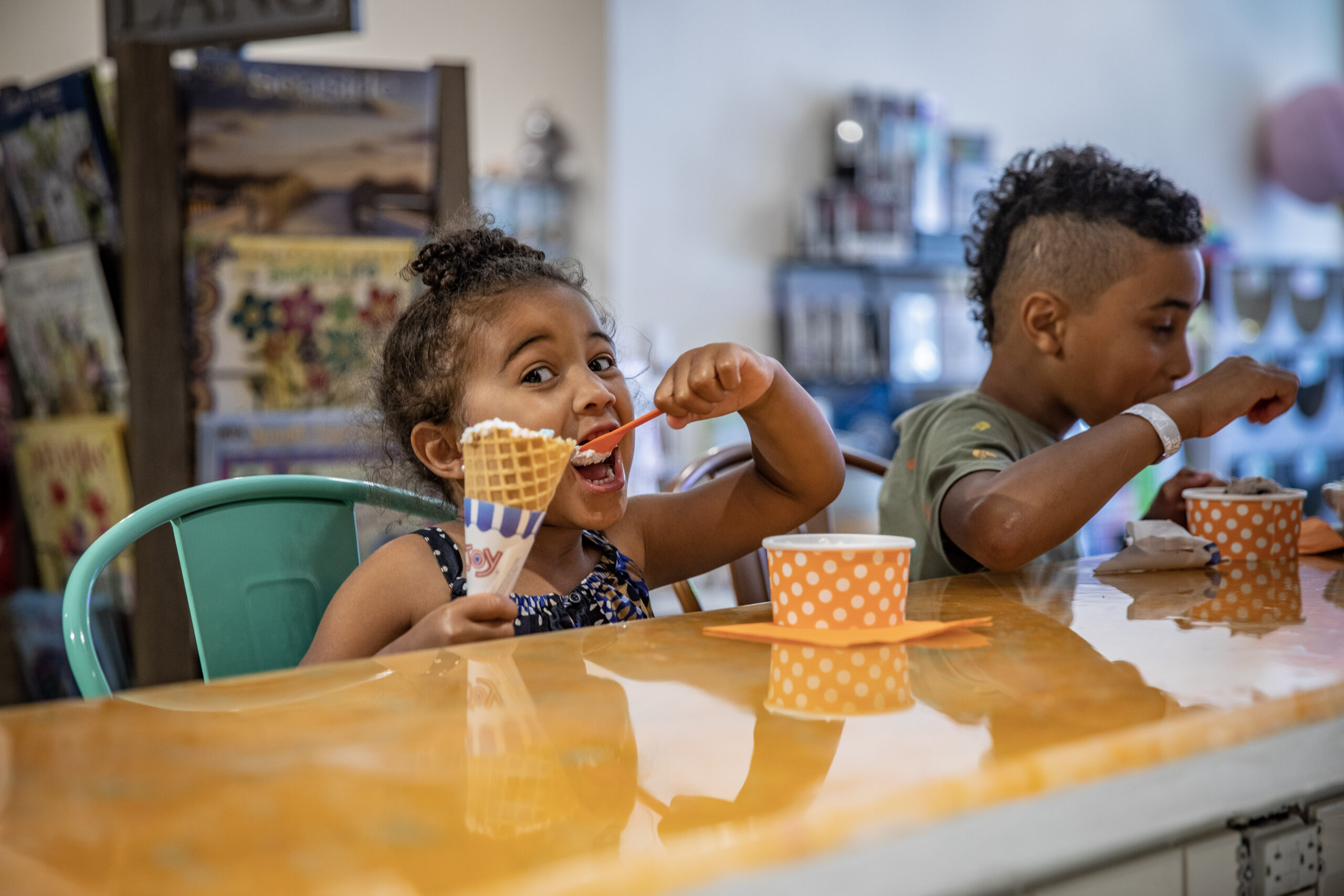 Two children enjoy homemade ice cream at Marmalade Moon in Ames, Iowa.