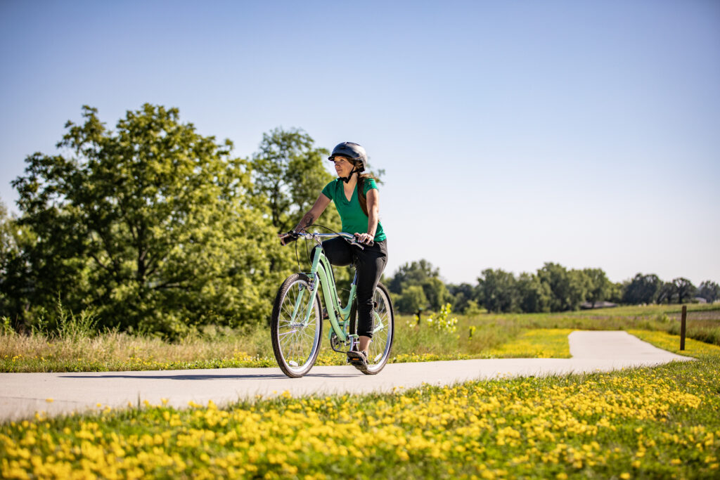 A woman riding her bike in Ames, Iowa.