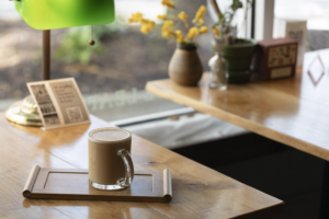 A Coffee Lovers' Perfect Weekend in Ames - Little Woods Herbs & TeasA cup of coffee sitting on a table in the coffee shop.
