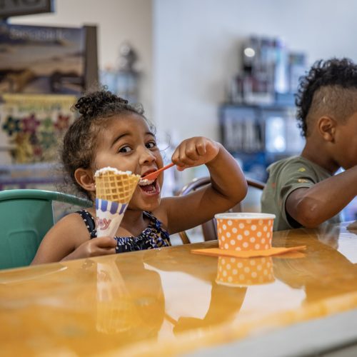 Two children enjoy homemade ice cream at Marmalade Moon in Ames, Iowa.